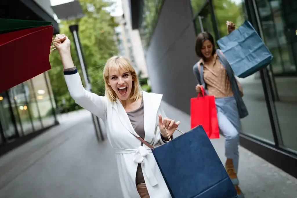 beautiful-happy-women-with-shopping-bags-walking-scaled