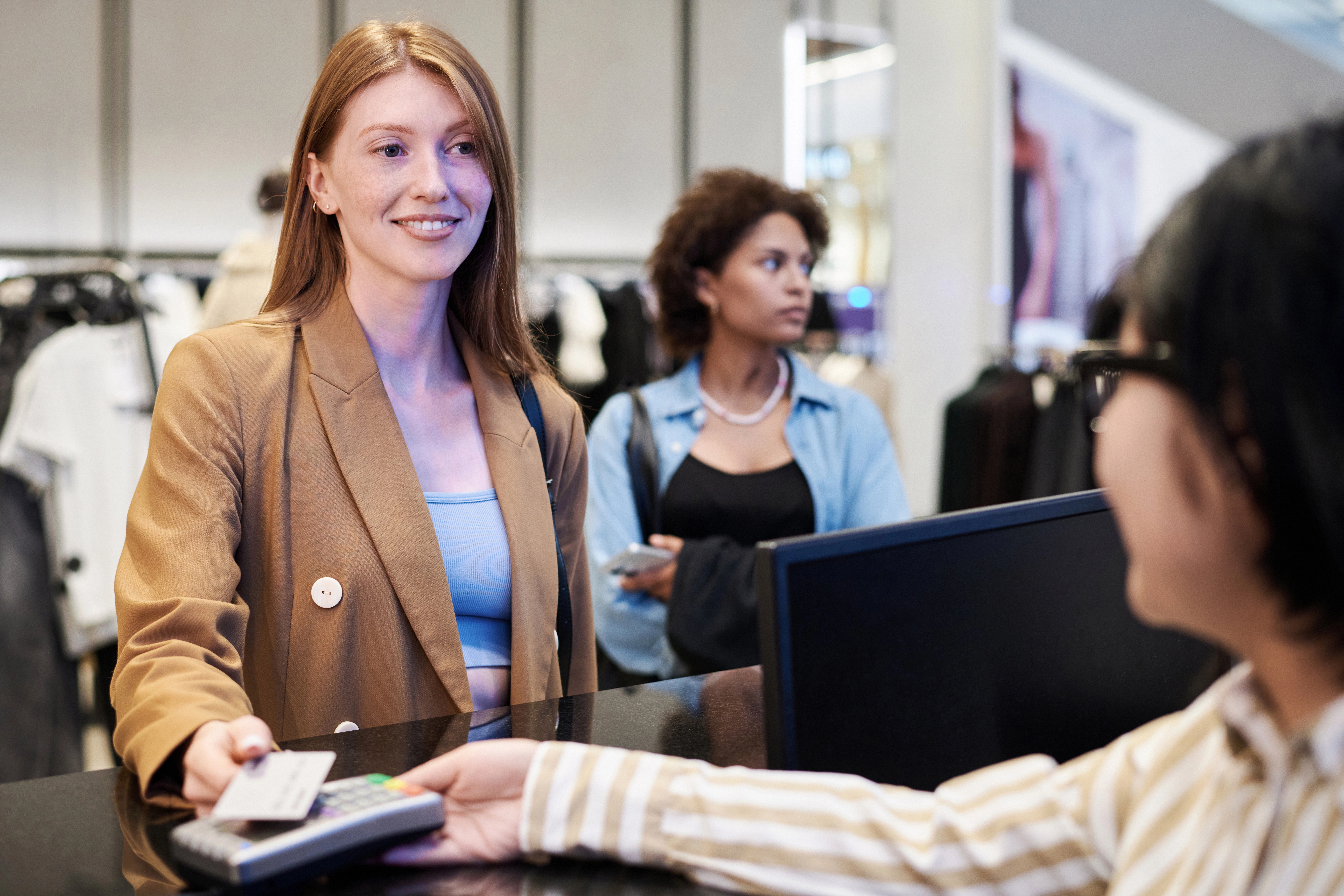 girl-paying-with-credit-card-at-clothing