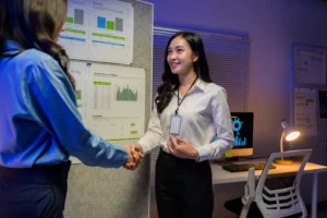 two-businesswomen-shaking-hands-after-successful